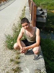 Small twink guy posing naked outdoors