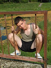 Small twink guy posing naked outdoors
