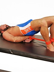 Athletic hunky bear playing with bounded daddy