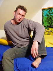 Nude gay stud solo relaxing in the bedroom