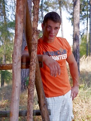 Beefy jock takes off his clothes in the wood