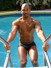Black man posing by the pool