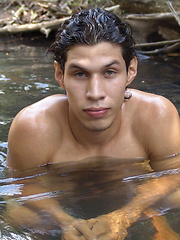 Ricardo sits down to jerk his uncut cock beside a stream