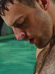 Riley lies on the pool side and plays with his hairy arse