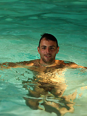 Riley lies on the pool side and plays with his hairy arse