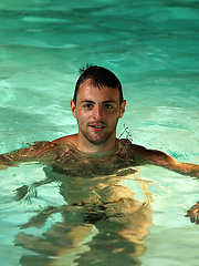 Riley lies on the pool side and plays with his hairy arse