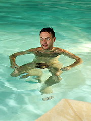 Riley lies on the pool side and plays with his hairy arse